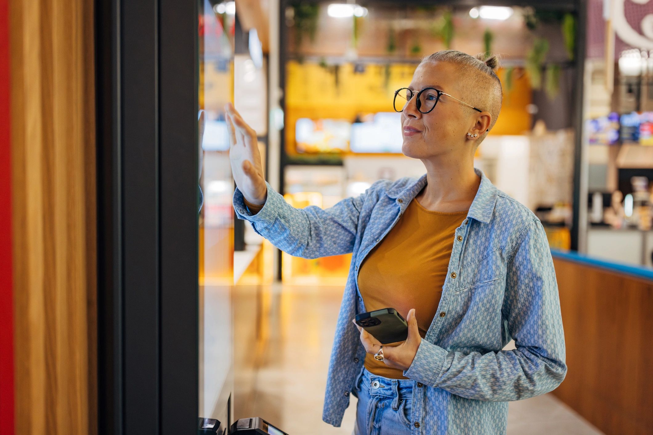 happy business owner with vending machine